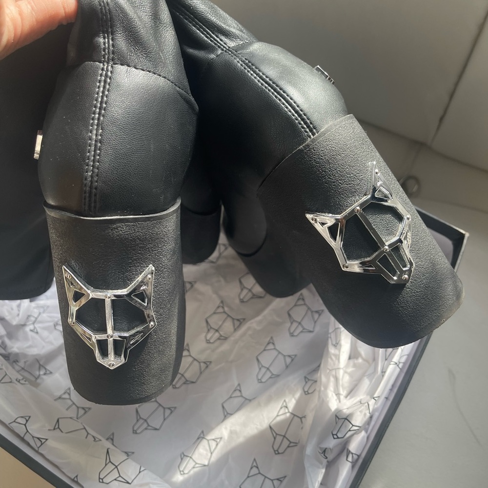 Naked wolf platform heeled black boots.